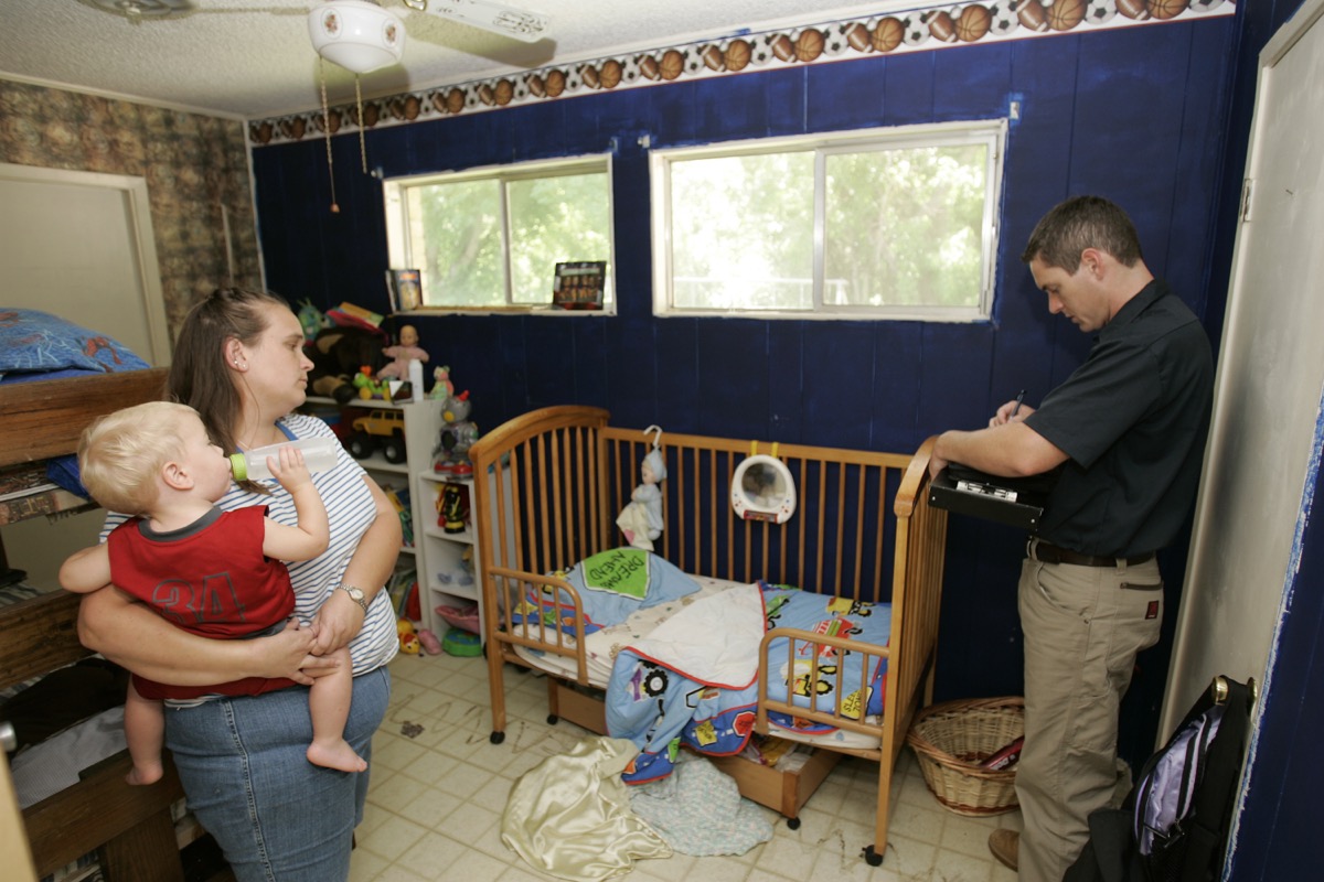 A FEMA contract inspector tallies flood damage inside a homeowner's house during the claims process